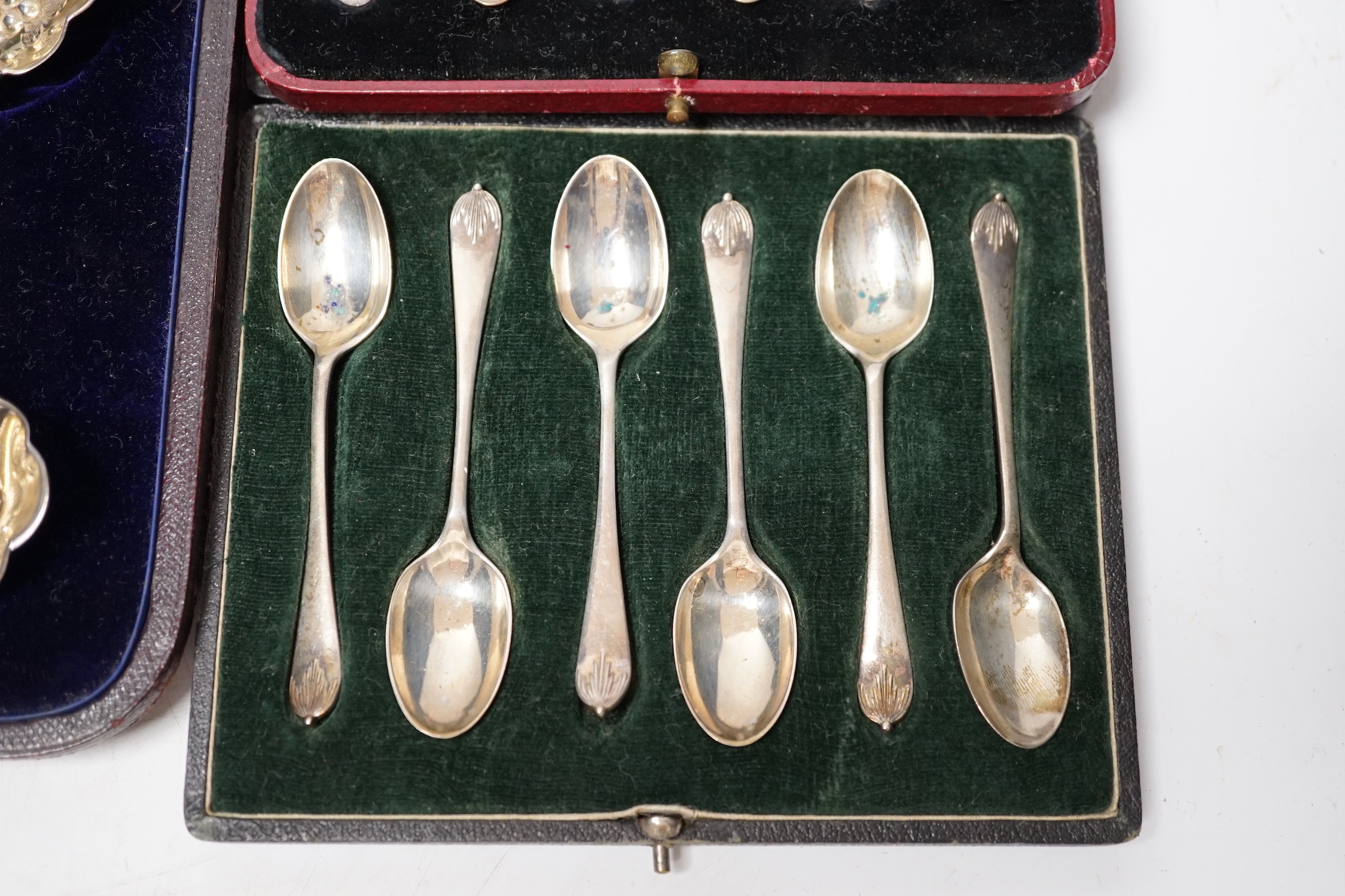 Three assorted cases of silver flatware, including two sets of six silver teaspoons and a 19th matched silver three piece serving and sifter spoon set.